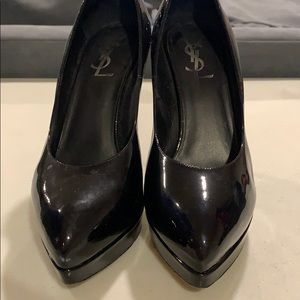 Woman’s black YSL platform patent leather pumps